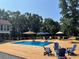 Backyard pool and deck with ample seating and umbrellas for relaxing in the sun at 8 Colonial Club Se Dr, Acworth, GA 30102