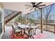 Outdoor dining on a screened-in porch with views of the surrounding landscape at 8 Colonial Club Se Dr, Acworth, GA 30102