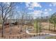 Lush property view featuring winding pathways, a cabin, and mature trees in a natural setting at 8 Colonial Club Se Dr, Acworth, GA 30102