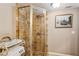 Tiled shower stall with glass doors and built-in shelving for bath products at 8 Colonial Club Se Dr, Acworth, GA 30102