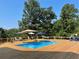 Swimming pool with a wood deck, umbrellas, lounge chairs, and hammock at 8 Colonial Club Se Dr, Acworth, GA 30102