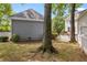 A backyard with trees, a white picket fence, and a view of the side of the house at 2149 Whittier Nw Pl, Atlanta, GA 30318