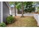 Lush backyard with a white picket fence, trees, and a partial view of the houses at 2149 Whittier Nw Pl, Atlanta, GA 30318