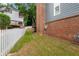 Backyard featuring a well-maintained lawn, a brick chimney and a white picket fence at 2149 Whittier Nw Pl, Atlanta, GA 30318