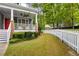 Spacious backyard features a well-maintained lawn with a charming white picket fence and lush greenery at 2149 Whittier Nw Pl, Atlanta, GA 30318