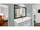 Bathroom showcasing a vanity with a framed mirror, white cabinets, and a view into the bedroom and hall at 2149 Whittier Nw Pl, Atlanta, GA 30318