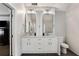 Bright bathroom with a double sink vanity, modern lighting, and ample storage space in white shaker cabinets at 2149 Whittier Nw Pl, Atlanta, GA 30318