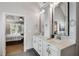 Elegant bathroom features a double sink vanity with marble countertop, modern fixtures, and access to the bedroom at 2149 Whittier Nw Pl, Atlanta, GA 30318