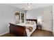 Bedroom featuring a wooden bed frame, window with blinds, and a bedside table with a lamp at 2149 Whittier Nw Pl, Atlanta, GA 30318