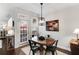 Cozy dining area featuring a wood table, modern light fixture, and a door to the outside at 2149 Whittier Nw Pl, Atlanta, GA 30318