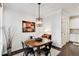 Cozy dining room featuring hardwood floors, stylish lighting, and view of the kitchen at 2149 Whittier Nw Pl, Atlanta, GA 30318