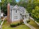 Charming two-story home with a brick chimney, landscaped yard, and inviting front porch at 2149 Whittier Nw Pl, Atlanta, GA 30318