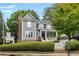 Charming home with a welcoming front porch, gray exterior, and landscaped yard at 2149 Whittier Nw Pl, Atlanta, GA 30318