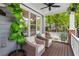 Relaxing front porch featuring wicker furniture, ceiling fan and view of the landscaped front yard at 2149 Whittier Nw Pl, Atlanta, GA 30318