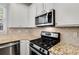 This kitchen features stainless steel appliances, granite countertops and plenty of storage space at 2149 Whittier Nw Pl, Atlanta, GA 30318