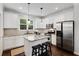 Modern kitchen with white cabinets, stainless steel appliances, and a center island with granite countertops at 2149 Whittier Nw Pl, Atlanta, GA 30318