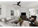Comfortable living room featuring a sectional sofa, TV, and a view to other rooms at 2149 Whittier Nw Pl, Atlanta, GA 30318