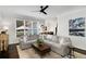 Spacious living room featuring a comfortable sectional sofa, large windows, and stylish decor at 2149 Whittier Nw Pl, Atlanta, GA 30318