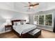 Spacious main bedroom features a tray ceiling, ceiling fan, and large window offering natural light and backyard views at 2149 Whittier Nw Pl, Atlanta, GA 30318