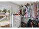 This walk-in closet with window features shelving, hanging racks, and a chest, maximizing storage space at 2149 Whittier Nw Pl, Atlanta, GA 30318