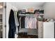 Neatly arranged walk-in closet with shelves, rods, and storage for clothing, shoes, and accessories at 2149 Whittier Nw Pl, Atlanta, GA 30318
