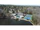 Aerial view of a lakefront community with tennis courts, a pool, and lush greenery at 3338 Breton Ne Cir, Brookhaven, GA 30319
