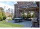 Spacious backyard with stone patio, outdoor kitchen, and dining area at 3338 Breton Ne Cir, Brookhaven, GA 30319