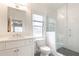 Bathroom featuring a glass enclosed shower, white vanity and a large, bright window at 3338 Breton Ne Cir, Brookhaven, GA 30319