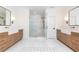Spacious primary bathroom featuring dual wood vanities, marble countertops, and a luxurious glass-enclosed shower at 3338 Breton Ne Cir, Brookhaven, GA 30319
