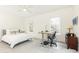 Bedroom with white walls, ceiling fan, and an adjustable desk by the window at 3338 Breton Ne Cir, Brookhaven, GA 30319