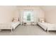 Bright and spacious bedroom with twin beds, soft pastel decor, and plush gray carpet at 3338 Breton Ne Cir, Brookhaven, GA 30319