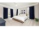 Bright bedroom features a bed with white linens, blue curtains, and a ceiling fan at 3338 Breton Ne Cir, Brookhaven, GA 30319