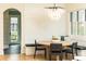 A cozy dining nook has bench seating, a round wooden table, and a modern chandelier at 3338 Breton Ne Cir, Brookhaven, GA 30319