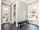 Inviting entryway with a bench, herringbone tile, and views to the backyard at 3338 Breton Ne Cir, Brookhaven, GA 30319