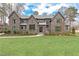 Stunning two-story brick home with lush front lawn and meticulously manicured landscaping at 3338 Breton Ne Cir, Brookhaven, GA 30319