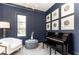 Modern home office featuring navy blue walls, piano, natural light, and art at 3338 Breton Ne Cir, Brookhaven, GA 30319