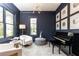 Modern home office featuring navy blue walls, piano, natural light, and art at 3338 Breton Ne Cir, Brookhaven, GA 30319