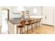 A bright kitchen features white cabinets, an island with bar stool seating, and modern pendant lighting at 3338 Breton Ne Cir, Brookhaven, GA 30319