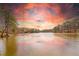 Scenic lake view surrounded by trees under an amazing sunset at 3338 Breton Ne Cir, Brookhaven, GA 30319