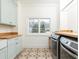 Bright laundry room with custom cabinets, countertops, patterned tile floor, and modern washer/dryer at 3338 Breton Ne Cir, Brookhaven, GA 30319