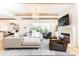 Spacious living room with a gray sectional, fireplace, and access to an outdoor patio at 3338 Breton Ne Cir, Brookhaven, GA 30319