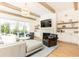 Bright living room features wood beams, fireplace, built-ins, neutral decor, and seamless access to the backyard at 3338 Breton Ne Cir, Brookhaven, GA 30319