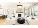 Bright living room with white brick fireplace, large windows, and comfortable seating arrangement at 3338 Breton Ne Cir, Brookhaven, GA 30319