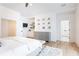 Bright primary bedroom featuring a white shiplap vaulted ceiling, built-ins, and hardwood floors at 3338 Breton Ne Cir, Brookhaven, GA 30319