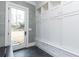 Stylish mudroom with herringbone floors, white cabinetry, and access to the backyard at 3338 Breton Ne Cir, Brookhaven, GA 30319