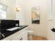 Chic powder room with black marble countertop, modern faucet, and decorative art at 3338 Breton Ne Cir, Brookhaven, GA 30319