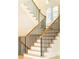 Elegant staircase with wooden handrail and black metal balusters at 3338 Breton Ne Cir, Brookhaven, GA 30319