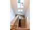 Elegant staircase showcasing light wood treads, dark iron railings, and natural light from skylight at 3338 Breton Ne Cir, Brookhaven, GA 30319