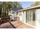 A wooden back deck features railings and glass sliding doors to the home's interior at 3485 Sheree Trl, Stone Mountain, GA 30087