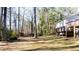A well-kept backyard featuring mature trees and the home's wood deck in view at 3485 Sheree Trl, Stone Mountain, GA 30087